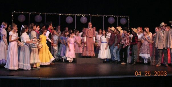 The author (in yellow) in her elementary school production of "Oklahoma!"