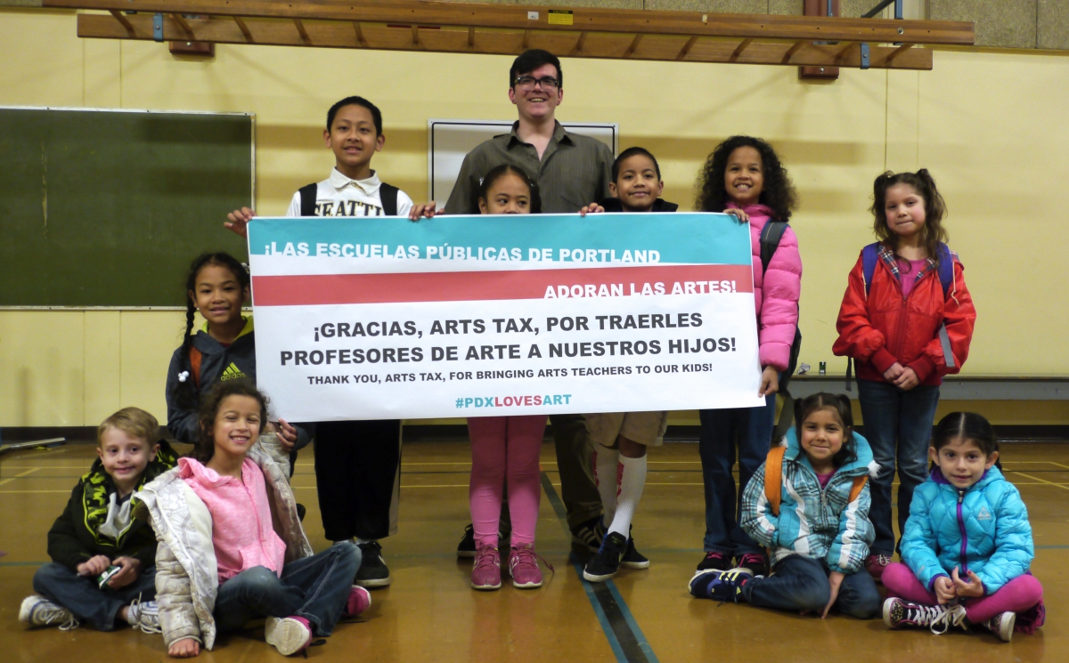 Students at Sitton Elementary in North Portland, and their art teacher Carlos Baca, celebrate the arts tax.
