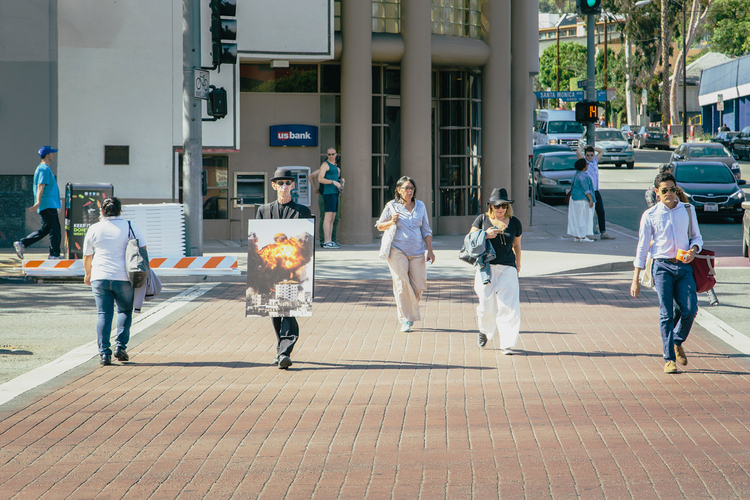 Walkers pass one another on their custom routes throughout the City causing unusual juxtapositions of images and text. Photo by Tony Coehlo.