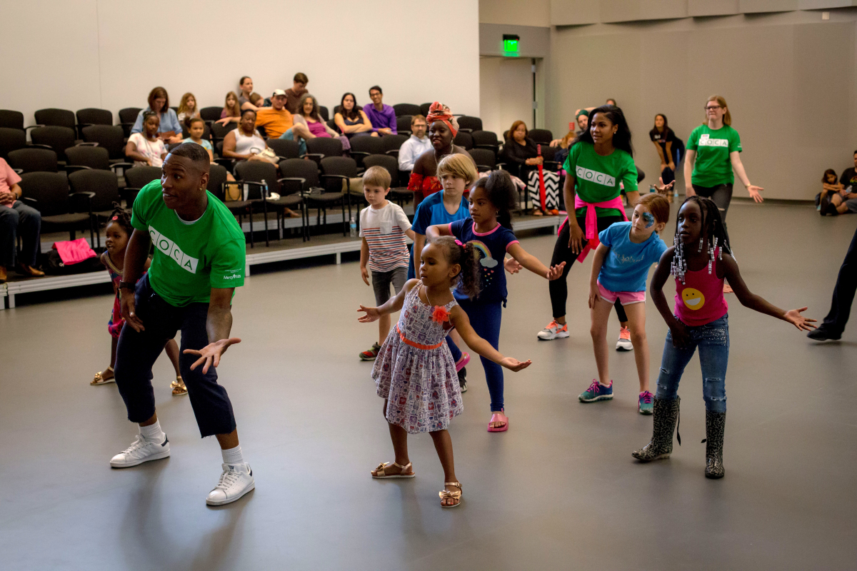 Community members dance at a COCA Open House.